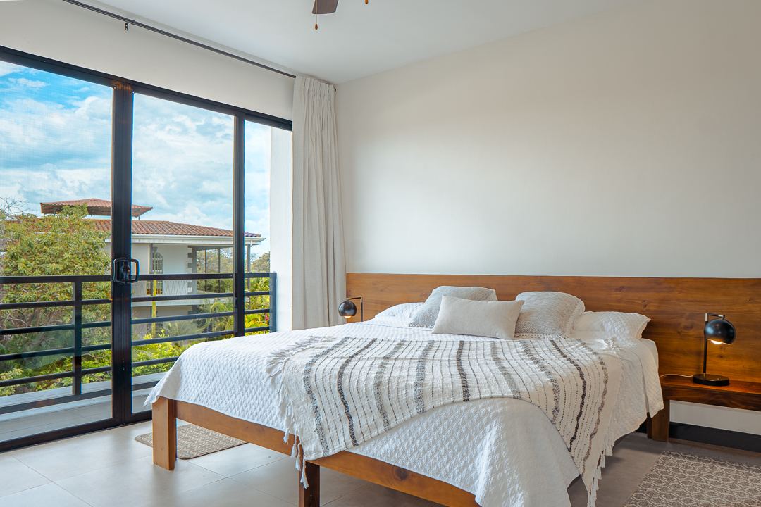 Ensuite king bedroom with balcony view at Cacique Retreat, Playas del Coco