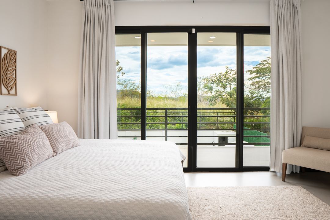 Ensuite bedroom with terrace access at Cacique Retreat vacation home