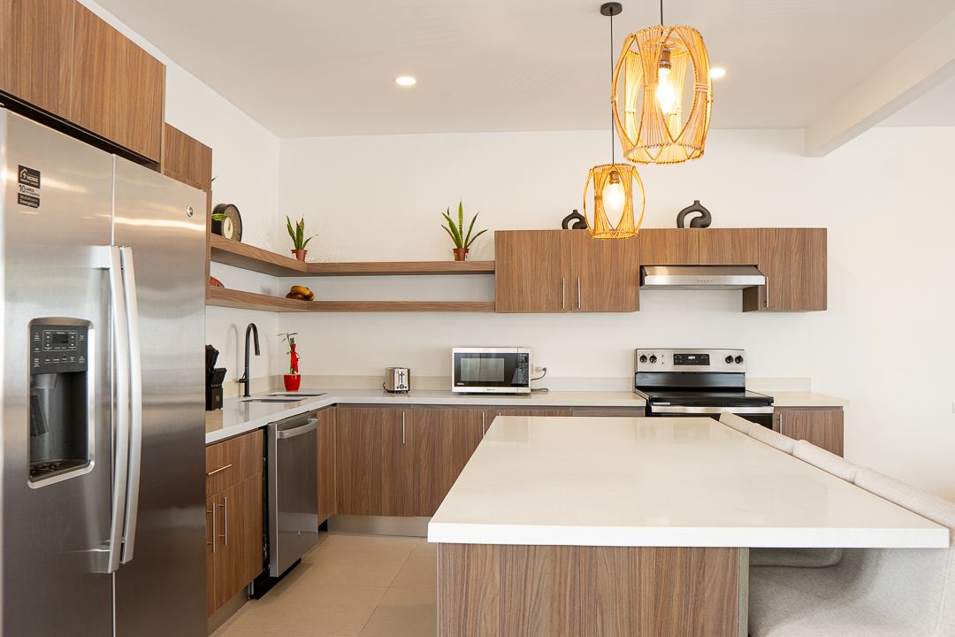 Full kitchen with island and stainless appliances at Cacique Retreat, Playas del Coco